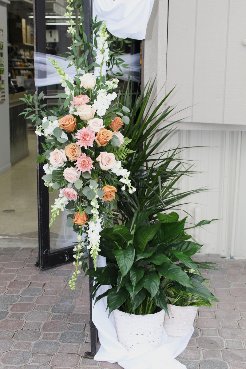 A variety of wedding floral arrangements, including lush centerpieces, elegant arch decor, free-standing ground installations, and delicate table accents. Featuring roses, peonies, wildflowers, and greenery, complemented by candles and soft lighting for a romantic ambiance.