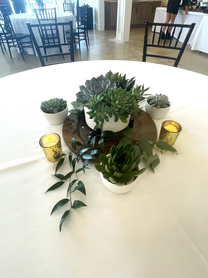 A variety of wedding floral arrangements, including lush centerpieces, elegant arch decor, free-standing ground installations, and delicate table accents. Featuring roses, peonies, wildflowers, and greenery, complemented by candles and soft lighting for a romantic ambiance.